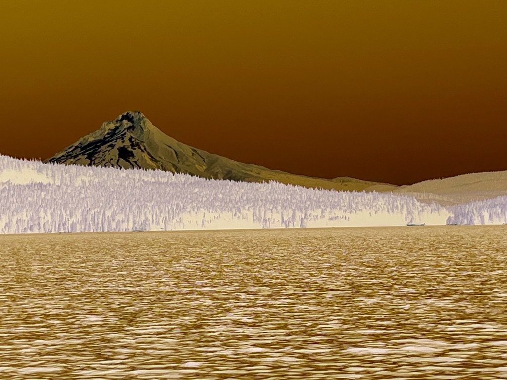 a color inverted photo of Mt. Hood from Timothy Lake - the sky and sea are a mix of browns, with a dark grey mountain in the background and white evergreen trees.